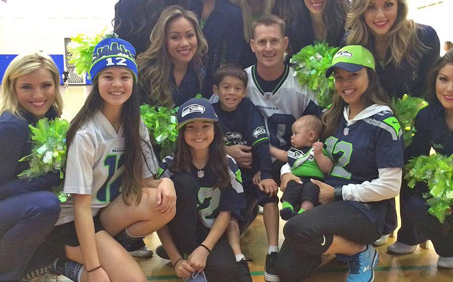Seattle Seahawk cheerleaders pose with some fans following an Armed Forces Entertainment show at Naval Air Station Sigonella in Sicily. The Sea Gals had to cut their European tour short after their uniforms were stolen when their bus made a quick stop in Rome.
Photo from Sea Gals' Twitter feed