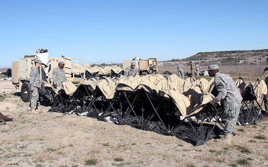 Soldiers with Headquarters and Headquarters Battalion, 1st Cavalry Division set up deployable rapid assembly shelter tents at Fort Hood, Texas, on Feb. 9, 2016. The Army announced Tueday, March 22, 2016, that about 500 soldiers from the 1st Cav. Div. are slated to deploy to Afghanistan.