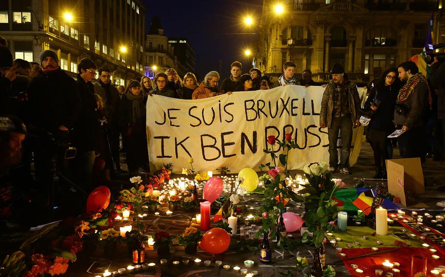 Members of the public gather at the Place de la Bourse in Brussels to leave messages and tributes following the terrorist attacks on Tuesday, March 22, 2016.