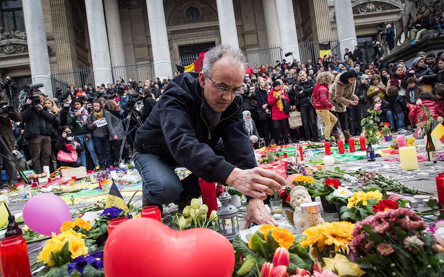 People gather to pay tribute to the victims of the Brussels attacks on March 23, 2016 in Brussels, Belgium.