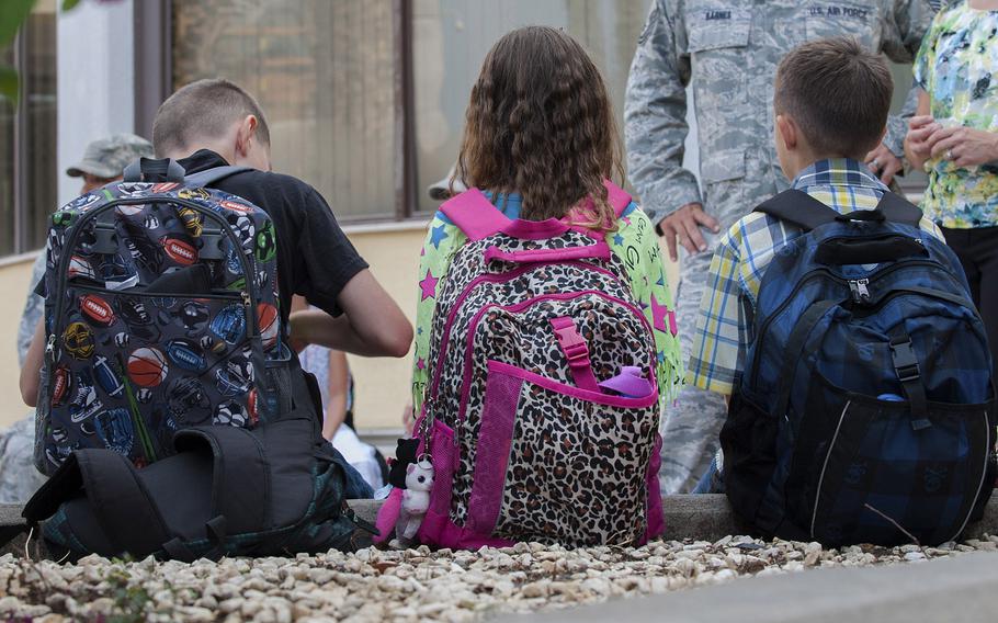 Children sit and wait to start their first day of school Aug. 26, 2013, Incirlik Air Base, Turkey. Classes at the school have been suspended since March 9, 2013, a day before the base was placed on complete lockdown. Classes could resume next week.