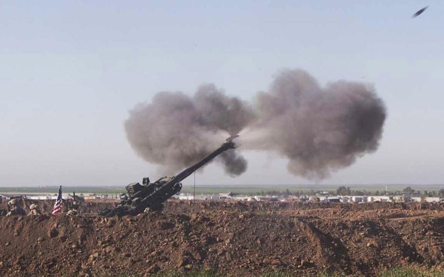 U.S. Marines with Task Force Spartan, 26th Marine Expeditionary Unit (MEU), on Fire Base Bell, Iraq, fire an M777A2 Howitzer at an ISIS infiltration route March 18, 2016.