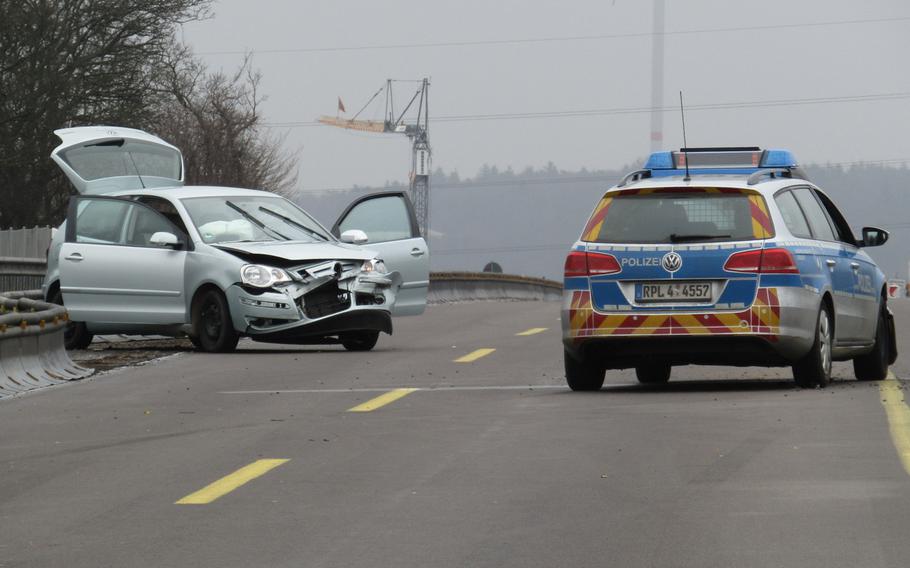 A damaged car sits on the autobahn after a 61-year-old driver was chased by German police for entering a U.S. military base in Kaiserslautern, Germany, on Saturday, March 19, 2016.