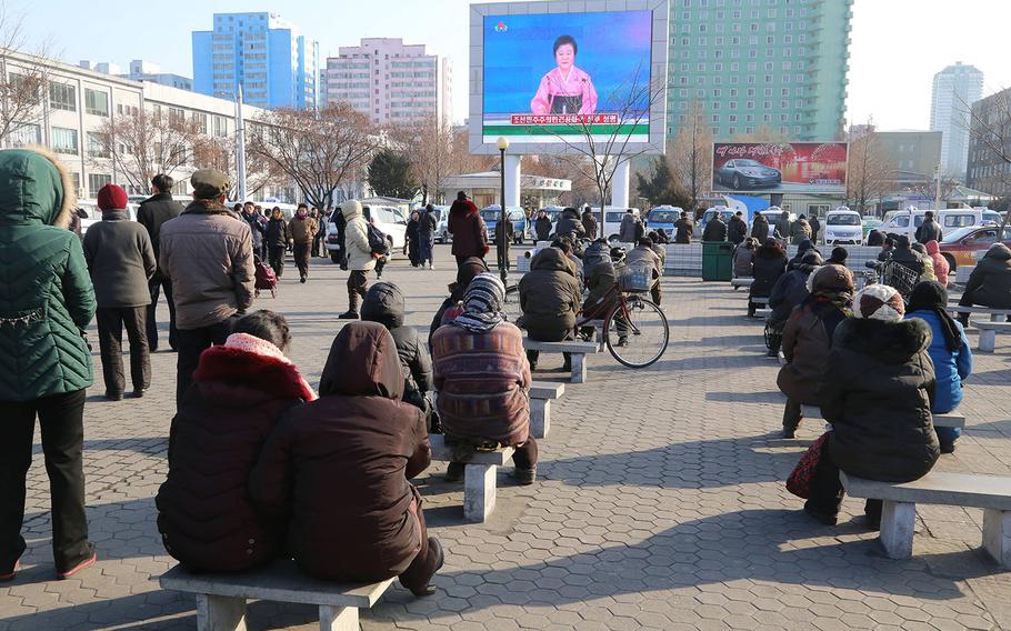 Pyongyang citizens gather in front of a big screen at Pyongyang Railway Station in Pyongyang, capital of the Democratic People's Republic of Korea, to watch a news report on the hydrogen bomb test on Jan. 6, 2016.
