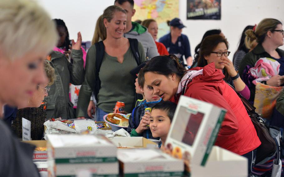 Dependents arriving from Incirlik Air Base, Turkey, take food offered by AAFES after arriving at Ramstein Air Base, Germany, March 31, 2016.
