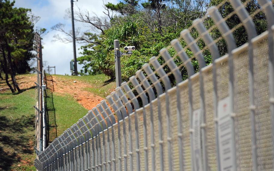 In a 2015 file photo, a tall fence and security camera surround Camp Schwab, Okinawa.