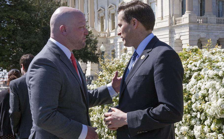 Congressman Seth Moulton, right, speaks with Paul Reickhoff, founder of Iraq and Afghanistan Veterans of America, after defending the G.I. Bill during a press conference on April 14, 2016, near the Capitol Building. 