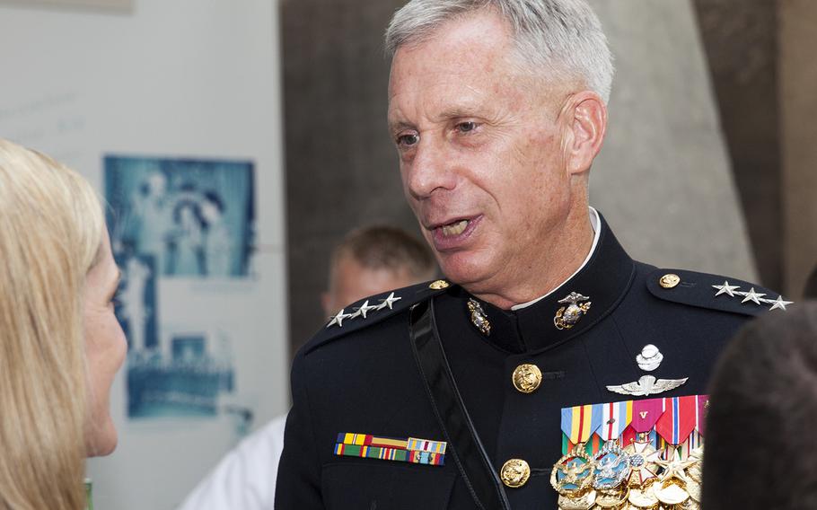 In a June, 2015 file photo, U.S. Marine Corps Lt. Gen. Thomas D. Waldhauser speaks with a guest during the sunset parade reception at the Women in Women in Military Service for America Memorial at Arlington, Va.
