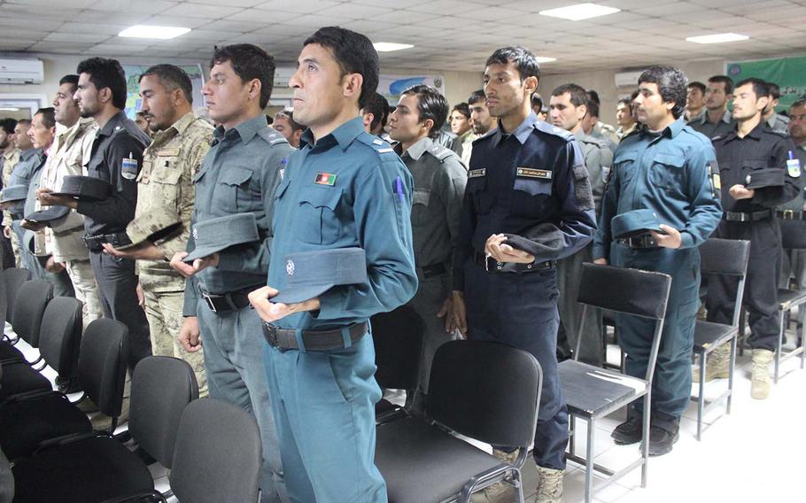 Members of the Afghan National Police stand to be recognized during their graduation from the Explosive Ordnance Disposal course at Central Training Center-Kabul on Feb. 20, 2016. The Taliban hanged two Afghan police officers in Paktika province on May 10, 2016.