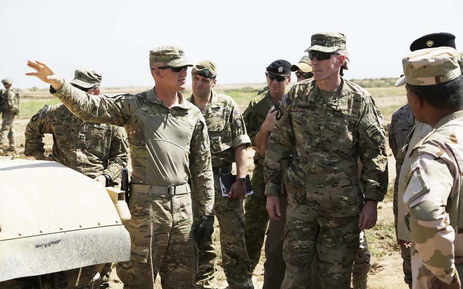 U.S. Army Maj. Gen. Gary Volesky, commander of the Combined Joint Forces Land Component Command Operation Inherent Resolve and the 101st Airborne Division, talks with Capt. Sean Fraser, 70th Armor Regiment, 2nd Armored Brigade Combat Team, 1st Infantry Division, during his visit to the Besmaya Range Complex, Iraq, April 14, 2016.