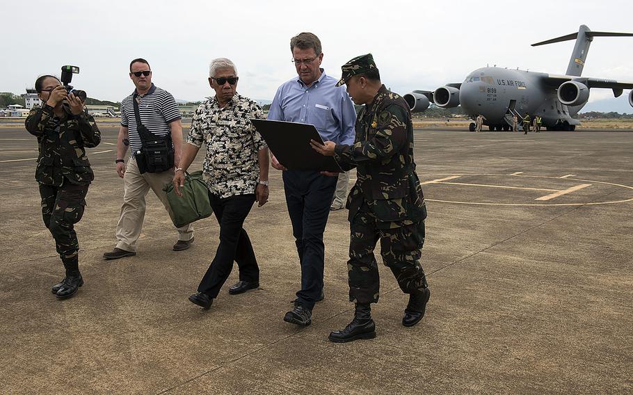 Secretary of Defense Ash Carter and Philippine Secretary of National Defense Voltaire Gazmin are briefed on future Enhanced Defense Cooperation Agreement plans at Puerto Princess Airport in Palawan, Philippines on April 15, 2016.
