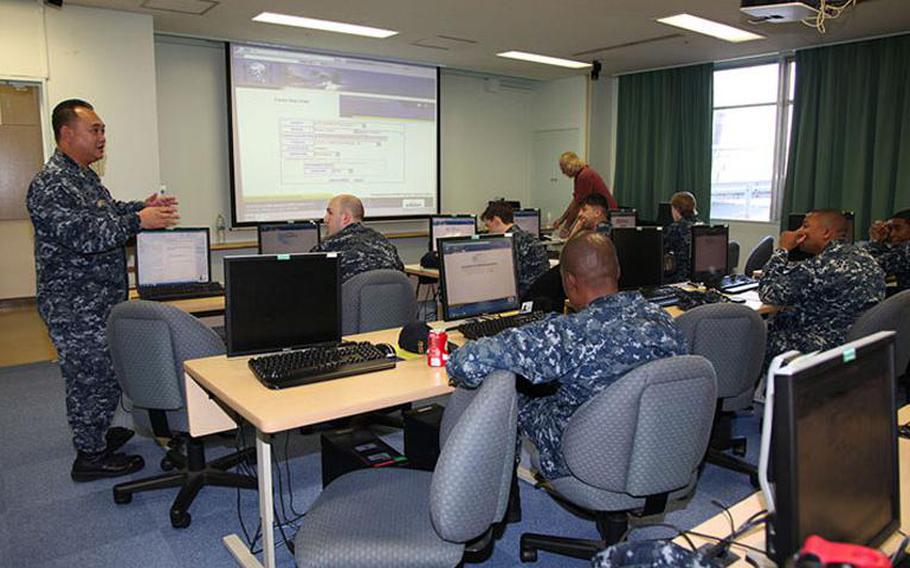 Khoi Pham (far left), then a U.S. Navy Senior Chief Petty Officer speaks with sailors during a food service training session at Yokosuka Naval Base in October 2015. Pham was sentenced to 179 days in the brig and reduction in rank after a military jury on Friday ruled that he sexually assaulted a woman in an off-base residence last year.