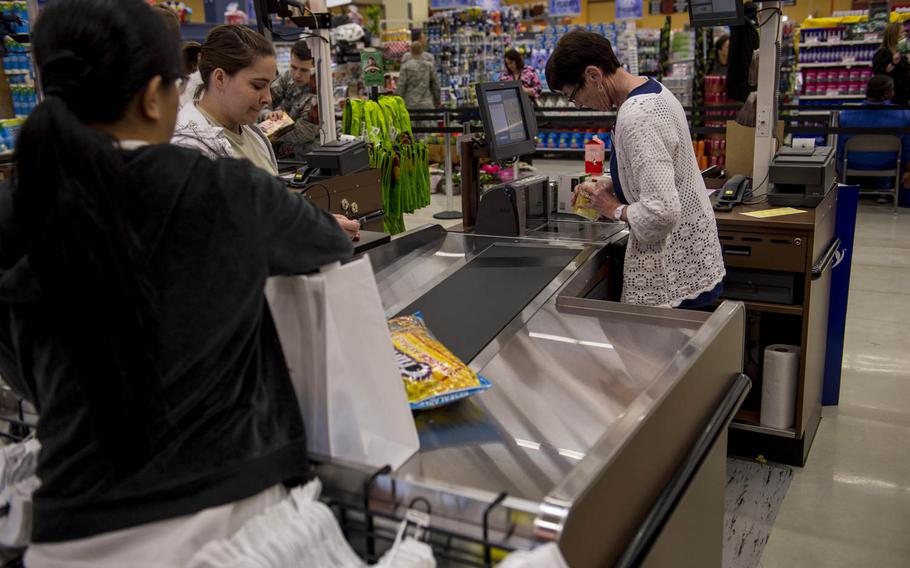A customer checks out at the cash register inside the new Spangdahlem commissary during the grand opening of the facility on Thursday, May 19, 2016, at Spangdahlem Air Base, Germany. Commissaries are among the facilities struggling with the hiring freeze.