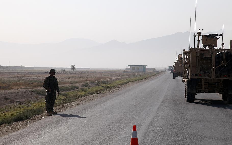 An Afghan National Army soldier stands guard in Parwan province, Afghanistan, on Oct. 9, 2012. A suicide bomber targeted a NATO convoy in Parwan province, wounding two civilians on on Saturday, May 21, 2016