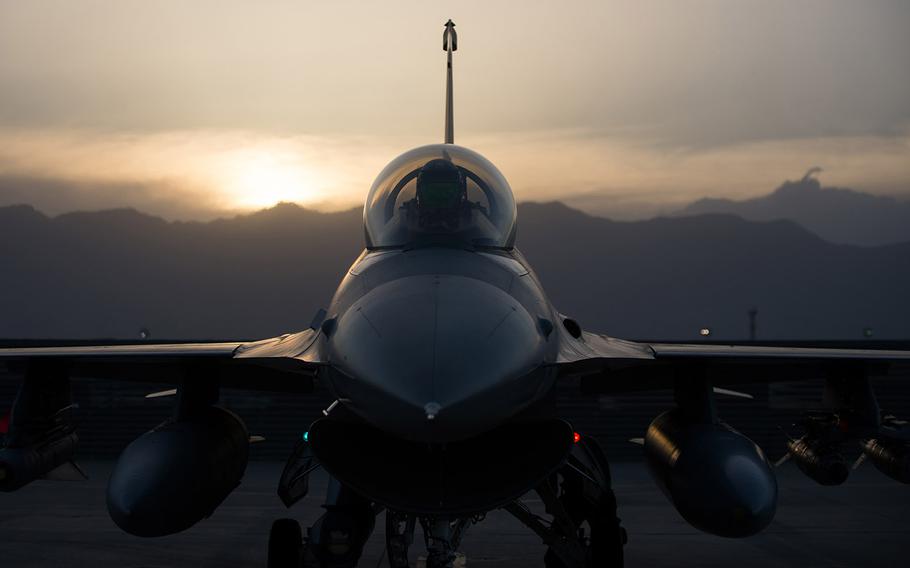 In a June, 2015 file photo, an F-16 Fighting Falcon aircraft pilot goes through preflight inspection before a combat sortie at Bagram Air Field, Afghanistan.