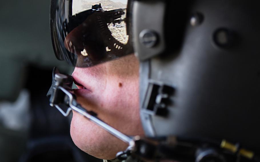 Army Sgt. Michael Buchanan looks out over Kabul, Afghanistan, as he mans an M2 .50-caliber machine gun on a CH-47 Chinook during a flight from Bagram Air Field on Tuesday, July 12, 2016.