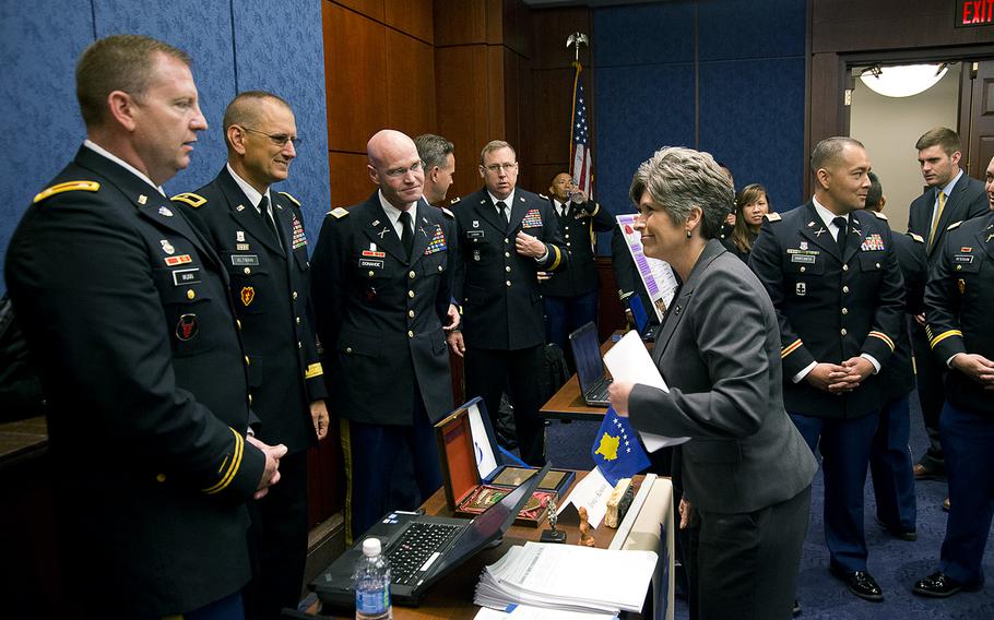 Sen. Joni Ernst, R-Iowa, speaks with servicemembers at the U.S. Capitol in Washington, on June 16, 2016. Ernst told Democratic Minority Leader Harry Reid on Thursday, July 14, that a filibuster of spending bills for the Defense Department showed that Democrats "don't care" about the safety of U.S. troops. 