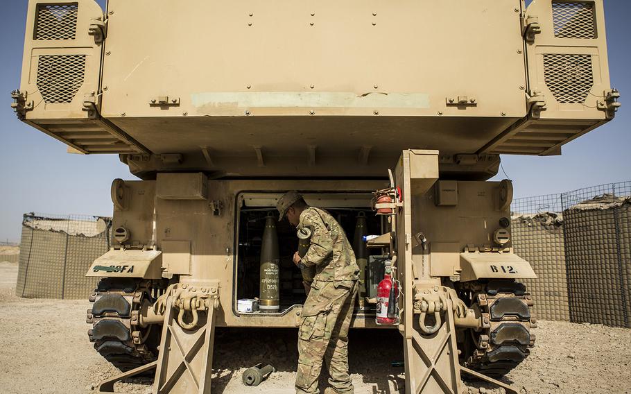 U.S. Army Soldiers with Battery C, 4th Battalion, 1st Field Artillery Regiment, 1st Armored Division, Task Force Al Taqaddum, conduct a resupply for an M109A6 Paladin howitzer with artillery rounds after a fire mission at Al Taqaddum Air Base, Iraq, June 27, 2016.