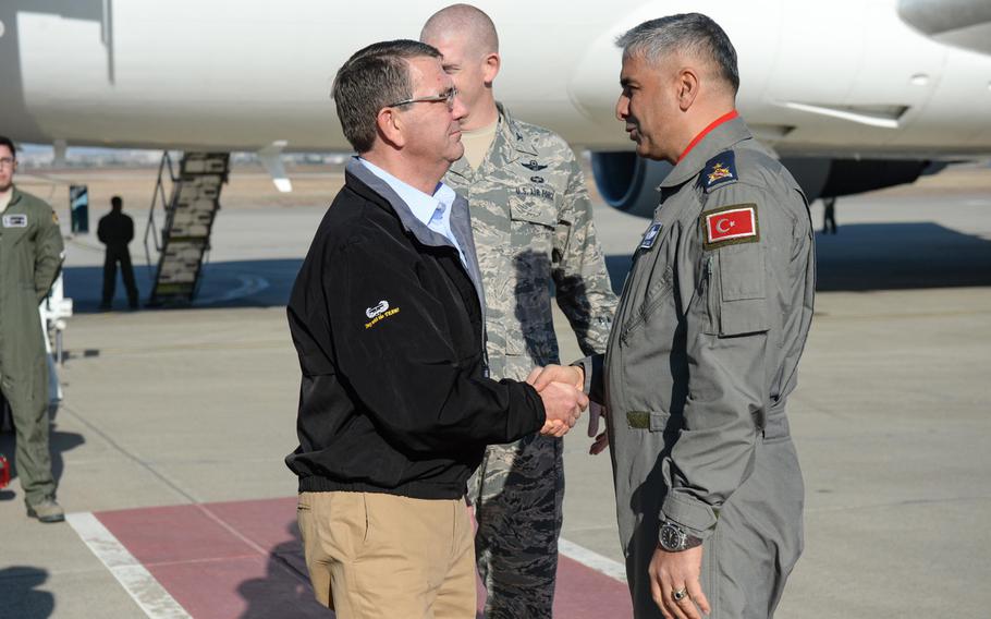 U.S. Defense Secretary Ash Carter shakes hands with Brig. Gen. Bekir Ercan Van, commander of the 10th Tanker Base Command, on Incirlik Air Base, Turkey, Dec.15, 2015. 