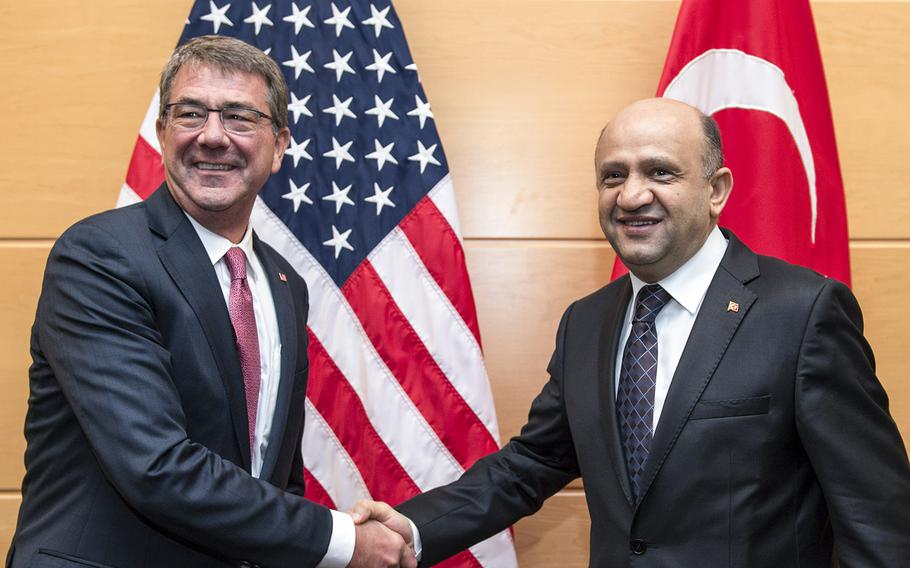 In a June 14, 2016 file photo, Secretary of Defense Ash Carter poses with newly-appointed Turkish Minister of Defense Fikri Isik at the NATO headquarters in Brussels, Belgium, June 14, 2016. Isik is one of several officials invited to Andrews Air Force Base on Wednesday to discuss strategies to counter the Islamic State group. It's not clear whether he will still attend the meeting.