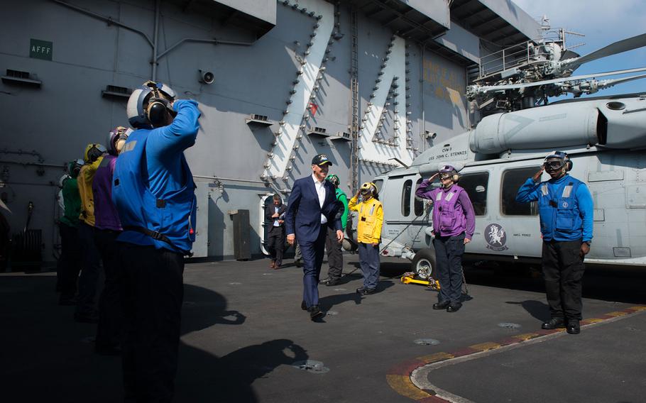 Rainbow sideboys render honors to Vice President Joe Biden following his visit to the USS John C. Stennis during the Rim of the Pacific maritime exercise on July 14, 2016.