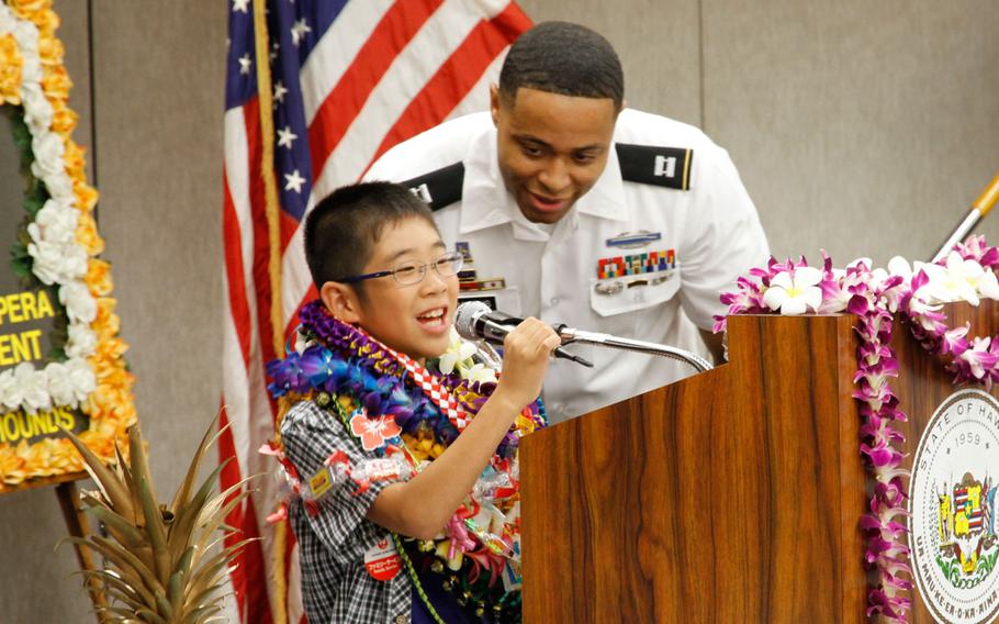 Kirito Uchikaneku introduces himself during a reception at the Honolulu airport July 29, 2016, as Capt. Joseph Simmons looks on.