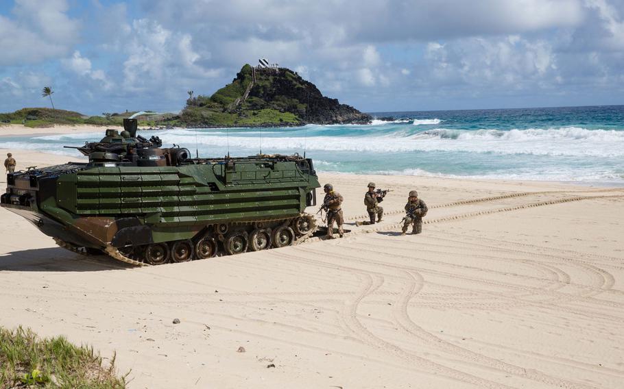 Marines follow an amphibious assault vehicle during the landing at Pyramid Rock Beach July 30, 2016 as part of the Rim of the Pacific exercise.