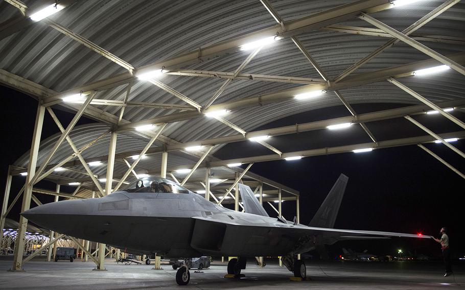 A U.S. Air Force F-22 Raptor crew chief (right) inspects the left wing during pre-flight inspection at an undisclosed location in Southwest Asia, July 11, 2016. The F-22 Raptors fly in support of Combined Joint Task Force-Operation Inherent Resolve.