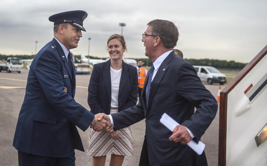 Air Force Brig. Gen. Christopher M. Short, the defense attache in London, greets Defense Secretary Ash Carter upon Carter's arrival in London, Tuesday, Sept. 6, 2016. Carter spoke at Oxford University on Wednesday. He is to visit Norway after his stop in the United Kingdom.