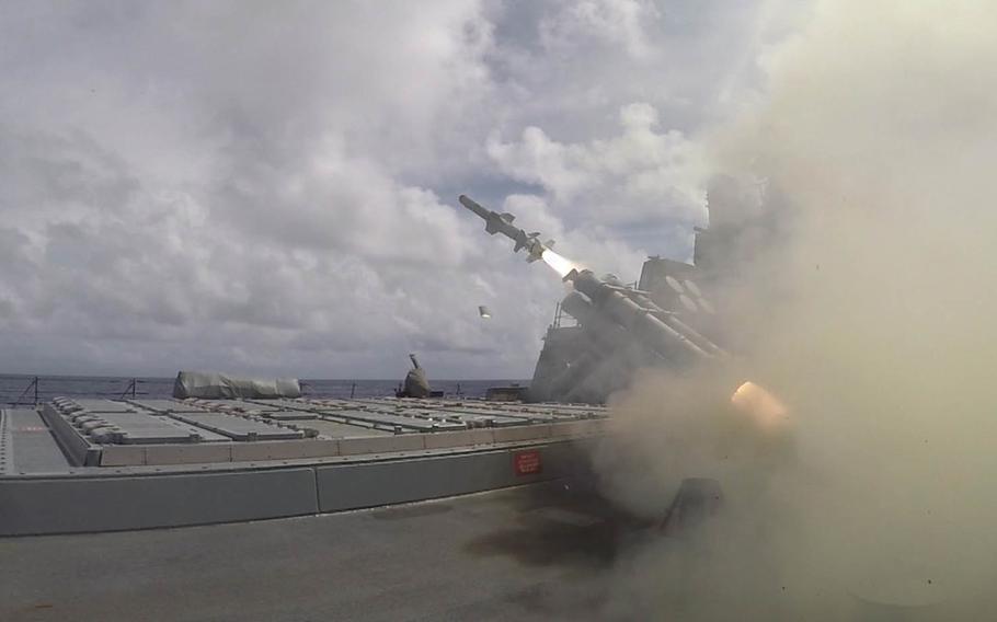 A harpoon missile is fired from the guided-missile destroyer USS Benfold during a sink exercise on Tuesday, Sept. 13, 2016, in the Philippine Sea. The target was the frigate USS Rent, which was retired in 2014 after about three decades of service.