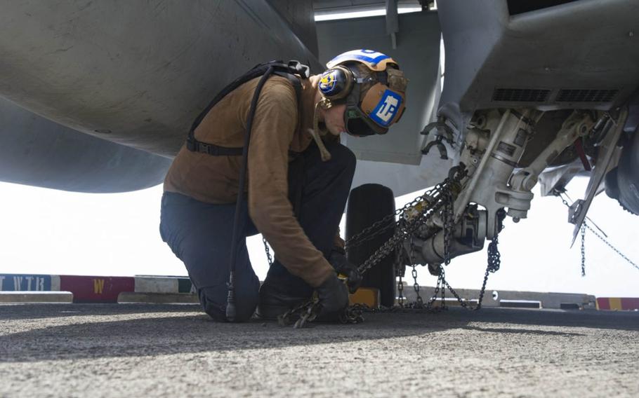 Petty Officer 3rd Class Kyle Hargis, an Aviation Machinist's Mate, secures an F/A-18F Super Hornet assigned to the Fighting Swordsmen of Strike Fighter Squadron 32 to the flight deck of the aircraft carrier USS Dwight D. Eisenhower July 18, 2016.Such tasks are among those performed by plane captains, junior sailors trained to ensure aircraft are in top shape and mission-ready.