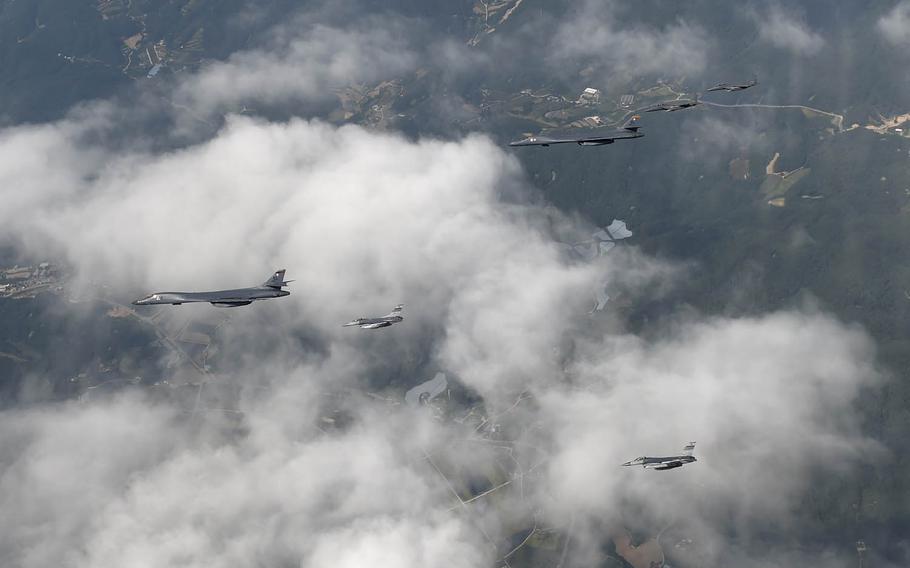 A formation of two B-1B Lancers deployed to Andersen Air Force Base, Guam, and four F-15K Slam Eagles assigned to Daegu Air Base, South Korea, fly over South Korea, Wednesday, Sept. 21, 2016.