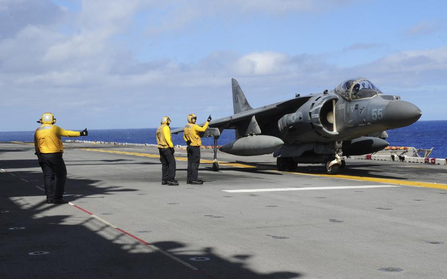 Flight deck personnel direct an AV-8B Harrier II, assigned to 13th Marine Expeditionary Unit, as it prepares to take off from the amphibious assault ship USS Boxer in the Pacific Ocean in August 2016. Okinawa's governor demanded Friday, Sept. 23, 2016, that Marine officials ground all Harrier jets pending an investigation into a Marine Harrier crash into the sea east of the island.