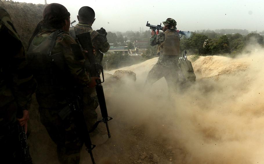 An Afghan soldier fires a rocket-propelled grenade at Taliban positions on the outskirts of Kunduz during mop-up operations in October 2015. The Taliban launched coordinated attacks Monday in embattled southern Helmand province and in the northern city of Kunduz, which was overrun by the insurgents a year ago.