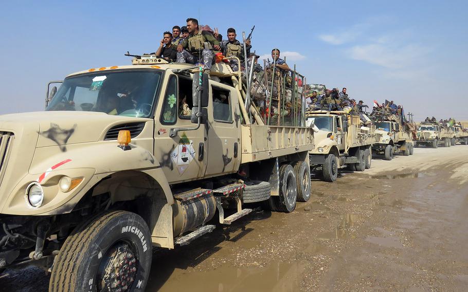 In an Oct. 26, 2016 file photo, Iraqi soldiers reinforce to guard the Bartella frontline, east of Mosul, Iraq.