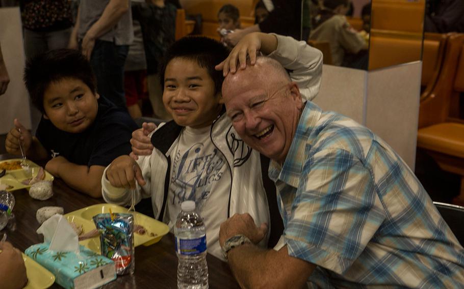 Cmdr. Ray Bailey interacts with the local Okinawan children at Yugafu Church as part of the Two Fishes Project, Nov. 23, 2016. The Two Fishes Project feeds children in poverty, providing them with meals so they can focus on their school studies. U.S. Marines and sailors with 3d Marine Expeditionary Brigade shared a traditional Thanksgiving meal with the Okinawan children. Bailey is the chaplain of III Marine Expeditionary Force Headquarters Group and is from Lincoln, Nebraska.