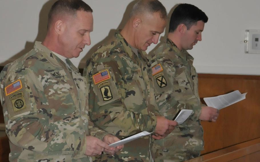 Maj. Gen Bryan R. Owens, the commanding general of U.S. Army Alaska, Command Sgt. Maj. Michael A. Ferrusi, the senior enlisted advisor, and Capt. Patrick R. McGrath, the aide de camp, sing during a Joint Base Elmendorf-Richardson Thanksgiving service and fellowship lunch at the Arctic Warrior Chapel on Nov. 21, 2016.