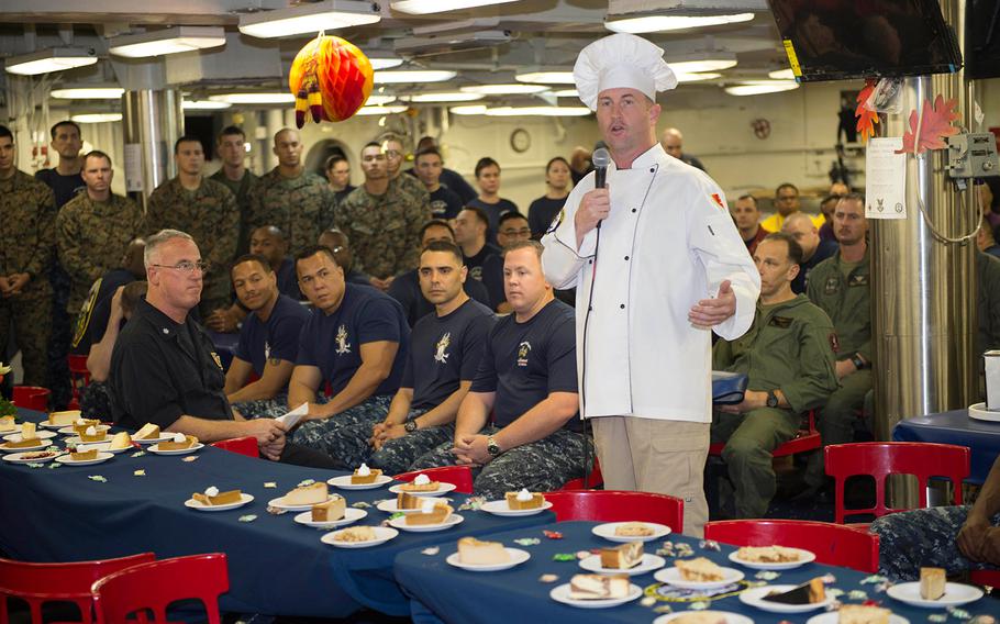 Capt. Mark Melson, commanding officer of the amphibious assault ship USS Makin Island addresses sailors and Marines before Thanksgiving Day dinner on the ship's mess decks in the Indian Ocean. The Makin Island, with the embarked 11th Marine Expeditionary Unit, celebrated Thanksgiving while underway in the U.S. 7th Fleet area of operations.