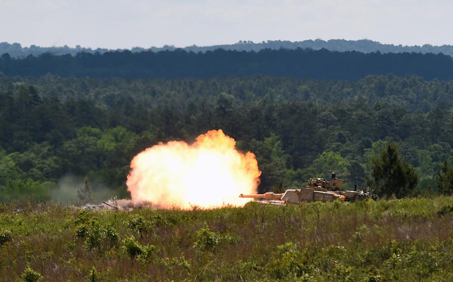 A tank commander directs his crew's fire from the hatch of their M1A1 Abrams tank while engaging targets on the range at Fort Benning, Ga., May 2, 2016. 