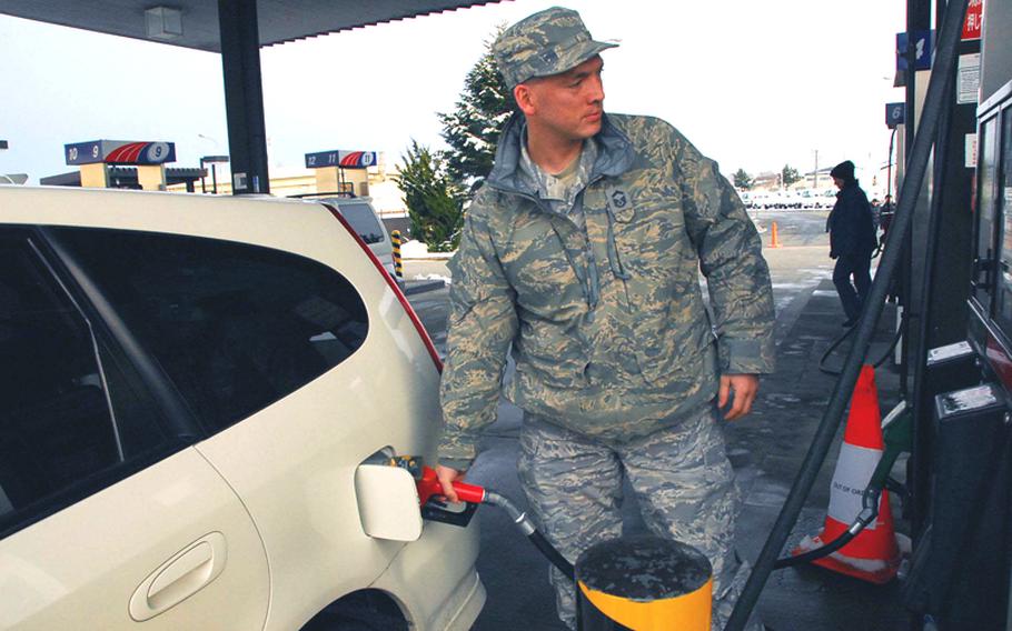 Senior Master Sgt. Gene Eastman of Everett, Wash., pumps gas at the AAFES gas station at Misawa Air Base in this March 2011 photo.