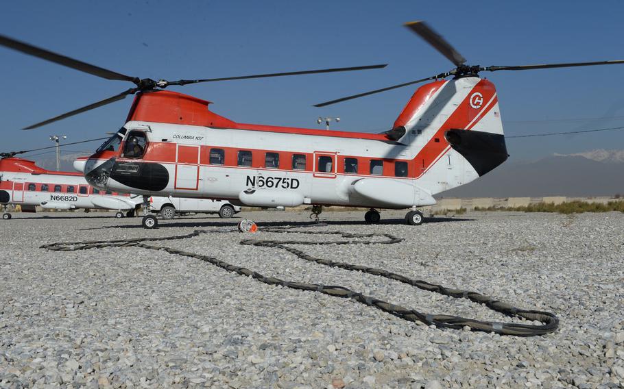 A V-107 helicopter operated by Columbia Helicopters waits to perform a sling load operation at Bagram Air Field, Afghanistan, Dec. 5, 2016. Officials say sling load operations, which are used to transport essential supplies like food, ammunition and spare parts, are increasing at Bagram.