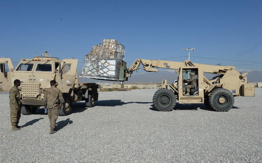 U.S. servicemembers at Bagram Air Field on Dec. 5, 2016, move rigged cargo that they will later sling load. The cargo consists of essential items needed to sustain forward operating bases in central and eastern Afghanistan.