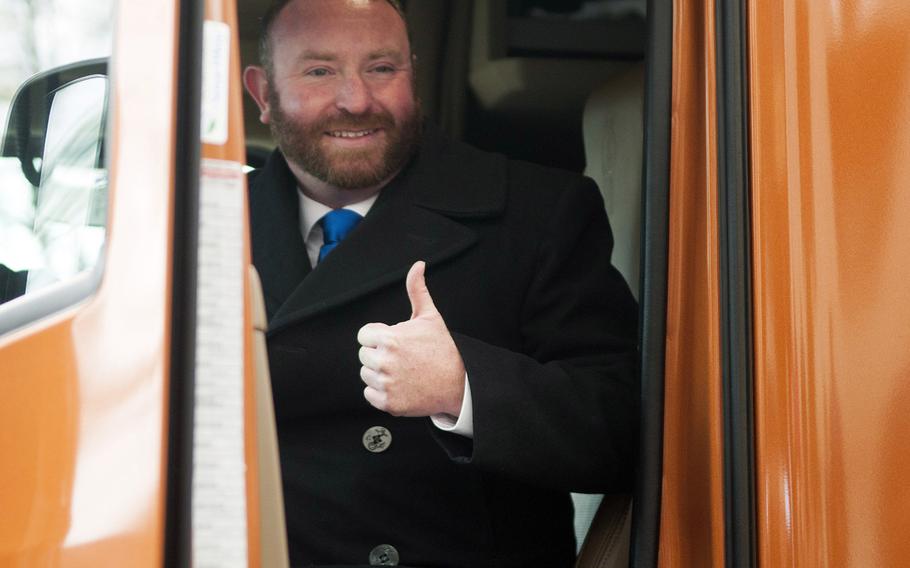 Troy Davidson, a Navy veteran from Pensacola, Fl., poses in his new T6680 semi-truck Friday, Dec. 16, 2016 outside the U.S. Chamber of Commerce Foundation in Washington. Davidson won the truck, worth $150,000, in a competition put on by Hiring our Heroes, Kenworth and FASTPORT.