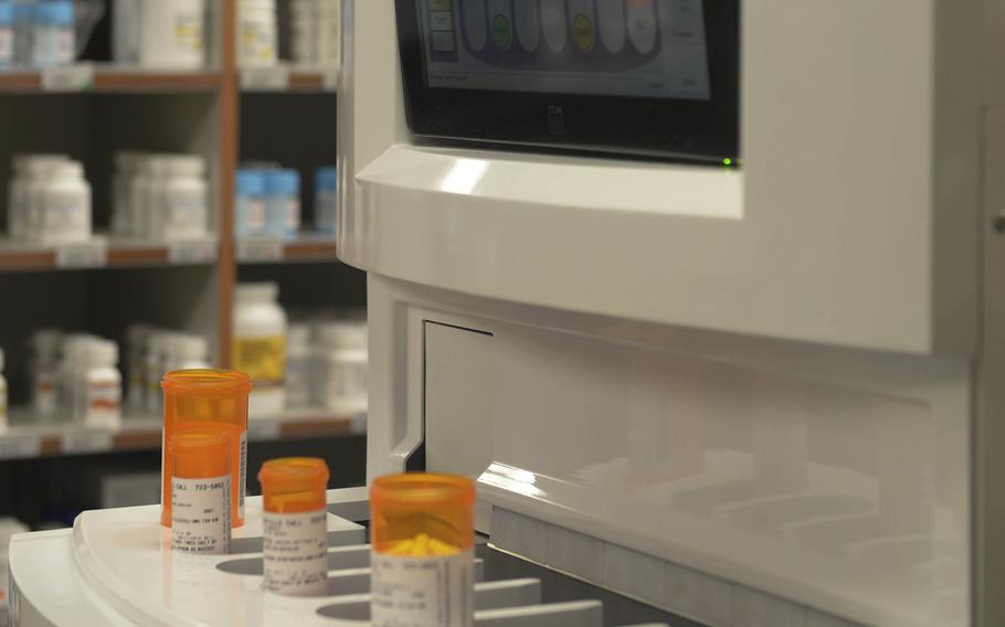 A machine fills prescription bottles at Minot Air Force Base, N.D., Aug. 17, 2016. 