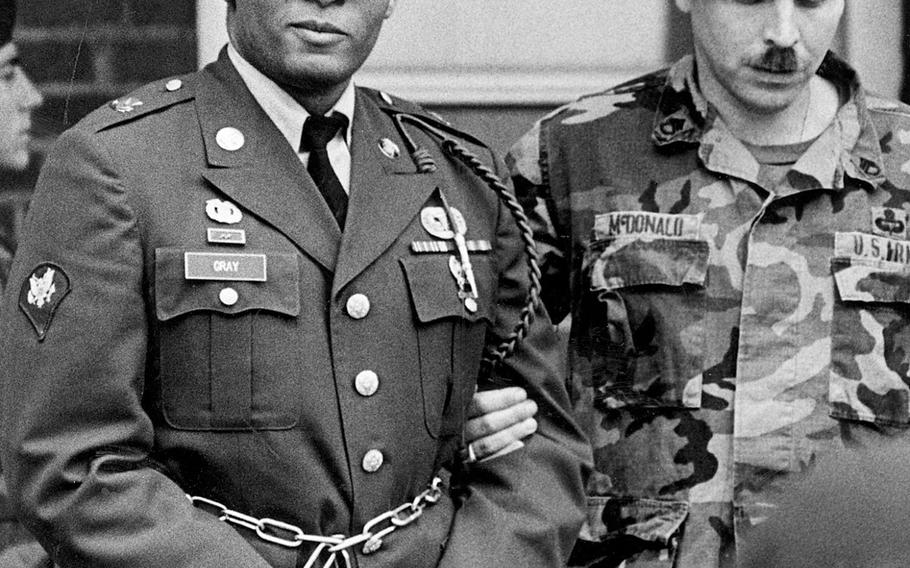 In this April 6, 1988, file photo, Ronald Gray leaves a courtroom escorted by military police at Fort Bragg, N.C.