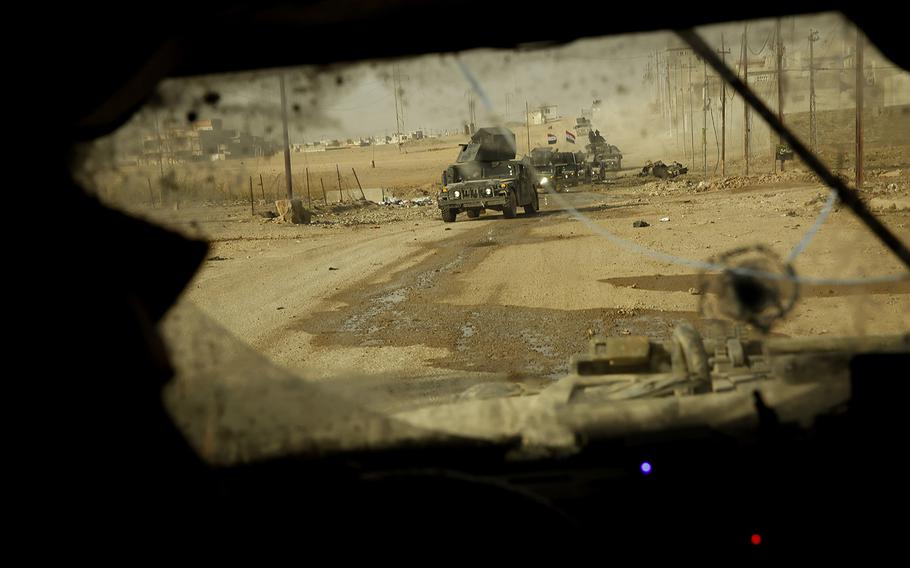 A convoy of Iraqi Special Forces troops moves through the Cahra neighborhood of Mosul on Nov. 12, 2016. 