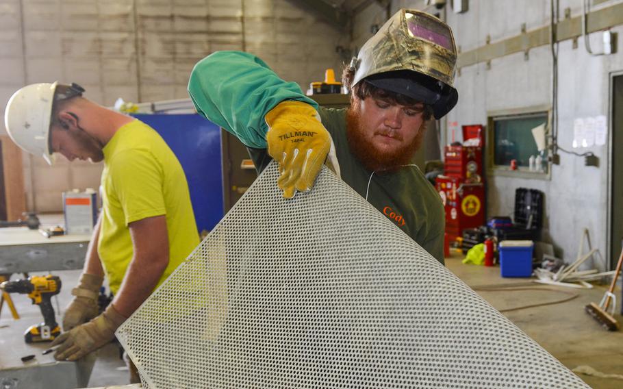 Civilian construction workers perform renovations on a South Carolina Air National Guard's structure at McEntire Joint National Guard Base, S.C., March 10, 2016. The Defense Department will now prioritize employee performance over all other factors if forced to lay off civilian workers.