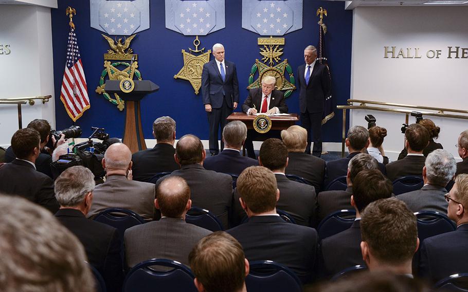 President Donald Trump signs an executive order Friday to rebuild the U.S. military during a visit Friday to the Pentagon.