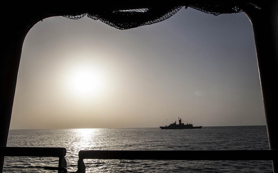 Royale Australian Navy frigate HMAS Arunta passes alongside the Royal Navy helicopter carrier HMS Ocean during exercise Unified Trident in the Persian Gulf Jan. 31, 2016. 
                Chris Church/Stars and Stripes