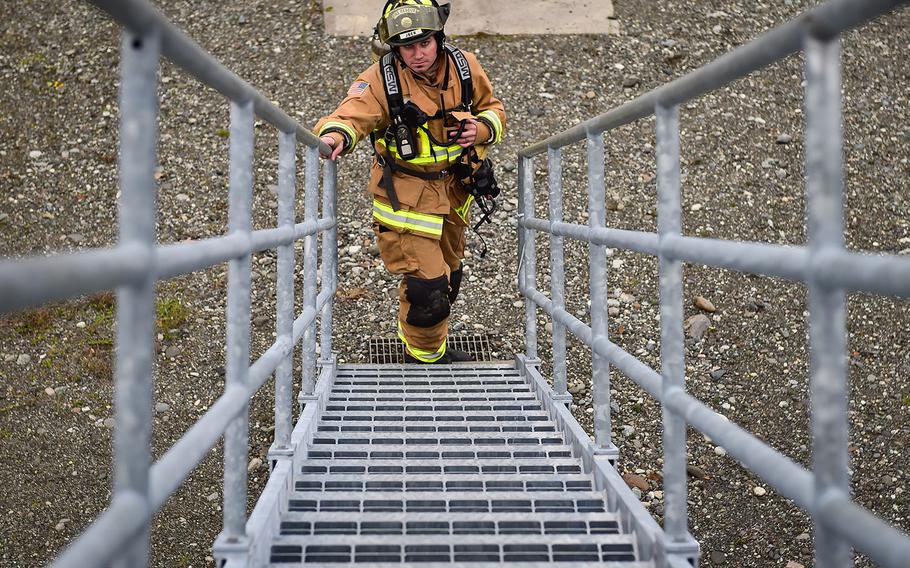 In a September, 2016 file photo, a firefighter waits for the order to begin training on a simulated aircraft fire at Joint Base Elmendorf-Richardson, Alaska.